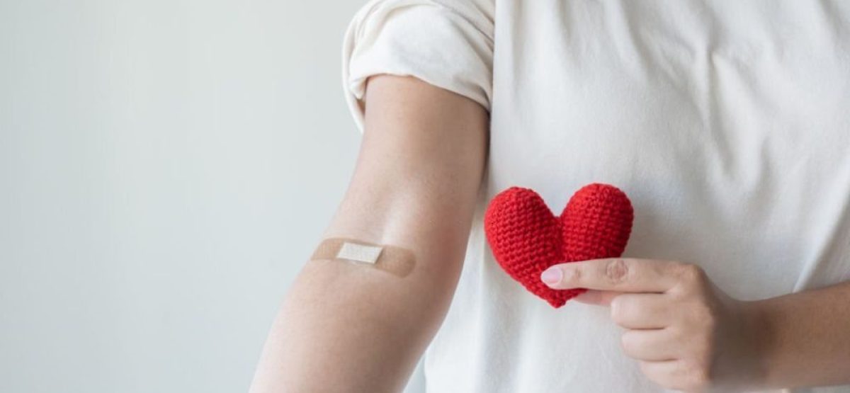 Blood donation concept. Give blood save up to three lives. Woman arm with the bandage plaster showing as a blood donation volunteer.